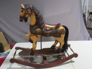lot 22 image: Hand Carved Wooden Toy Rocking Horse 26 with Cast Iron Wheels