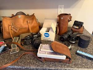 lot 56 image: Minolta XE-7 Film Camera Bundle with Lenses, Vivitar Accessories, and Leather Bags