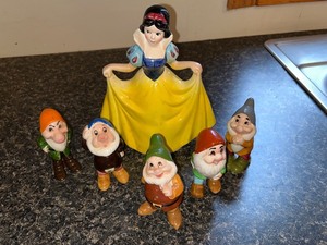 lot 13 image: Snow White and the Six Dwarfs Porcelain Figurine Set
