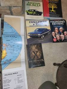 lot 114 image: Book Collection with World Map - Muscle Cars, Genealogy, Founding Fathers, The Hooked X