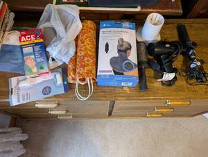 lot 21U image: Personal Care and Wellness Lot Wrist Brace, Neck Heating Pad, Hair Dryer, and Accessories