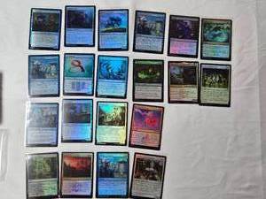 lot 151 image: Magic The Gathering Foil Cards Including Copycrook, Depth Defiler, and Reflective Golem with copyright years including 2021 and 2024