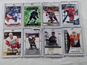 lot 375 image: Lot of 8 Hockey Cards All in Magnetic One Touch Cases Featuring Key Players Including Leon Draisaitl, Cale Makar, and Matty Beniers