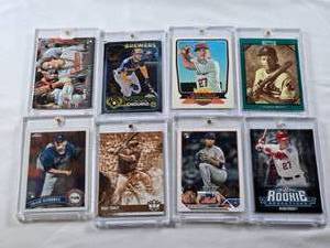 lot 385 image: Lot of 8 Baseball Cards in Magnetic One Touch Cases with Mike Trout, Jackson Chourio, George Brett, Adley Rutschman, Craig Kimbrel, and Kodai Senga. Includes Rookie cards