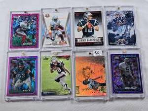 lot 386 image: Lot of 8 Football Cards with 7 in Magnetic One Touch Cases Featuring Jimmy Garoppolo Rookie, Xavier Worthy, Jason Sehorn, Jason Kelce, Chris Spielman