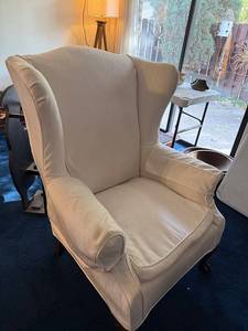 lot 74 image: Elegant Cream Upholstered Wingback Chair