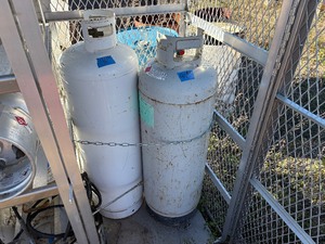 lot 46 image: (2) Propane Tanks The shorter tank reads TW 69.8. Cannot read the taller tank