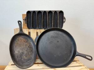 lot 5 image: 3 cast-iron pieces- corncob cornbread pan, serving skillet, and a flat round skillet