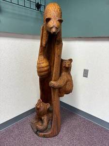 lot 57 image: 3 bears and a hive chainsaw carved totem by Vernon, S Pine, 2005