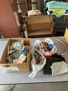 lot 41 image: Sewing and Needlecraft Supplies Including Spools, Fabric, and Tools