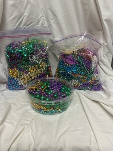 lot 57 image: Mardi Gras Beads in Two Bags and One Container