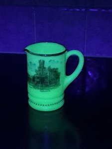 lot 172 image: Uranium Glass Souvenir Creamer Depicting Anamosa State Penitentiary