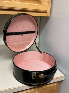 lot 202 image: Singer Black Vinyl Hat Box with Pink Lining and Gold Graphics