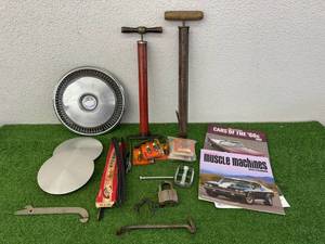 lot 52 image: Automotive Items - Hubcaps, Air Pumps, Spark Plugs & Advertising Pry Bar