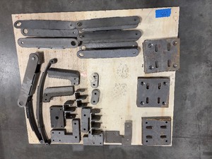 lot 155 image: Flat bar braces, leaf springs, steel L-shaped brackets, steel slotted plates
