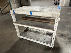 lot 211 image: Mobile workbench with open sides and a middle and lower shelf. 43 x 24