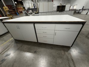 lot 225 image: 4x8 steel base wlaminated top bottom has one side open, one side retrofitted wdrawers, 2-door cabinet
