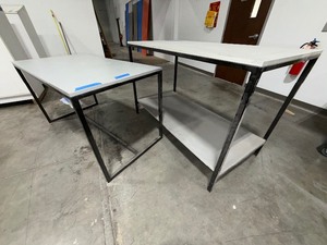 lot 236 image: 2 task tables laminated tops and black metal frames. Measurements 60 x 30 x 34 and 60 x 30 x 39