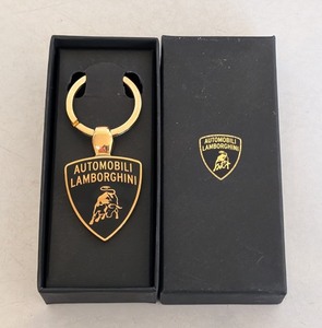 lot 292 image: ML - Automobili Lamborghini Gold-Tone Shield Keychain with Box
