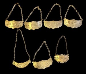 lot 109R image: K - Set of 7 Vintage Brass Decanter Labels for Spirits