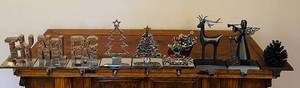 lot 76C image: LR - Collection of 8 Holiday Metal Stocking Holders with Christmas and Winter Designs