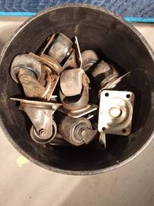 lot 100 image: Bucket of swivel wheels