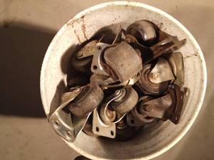 lot 105 image: Bucket of swivel and stationary wheels