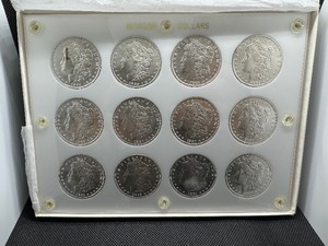 lot 5 image: Twelve Uncirculated Morgan Dollars in a Capital Holder 1904-O (4) 1885 1885-O (2) 1881-O (4) 1884-O - Beautiful Coins - Extreme Mint Luster