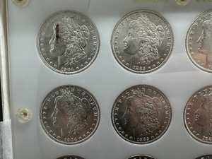 Twelve Uncirculated Morgan Dollars in a Capital Holder: 1904-O (4); 1885; 1885-O (2); 1881-O (4); 1884-O - Beautiful Coins - Extreme Mint Luster!