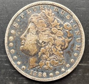 lot 25 image: 1886-O Morgan Silver Dollar