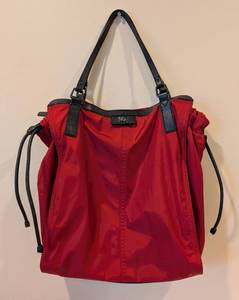 lot 47 image: LL - Burberry Red Nylon Tote Bag with Black Leather Handles