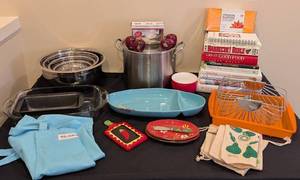 lot 134 image: LL - Assorted Kitchenware Collection with Mixing Bowls, Bakeware, Apron, Dishes, and Cookbooks