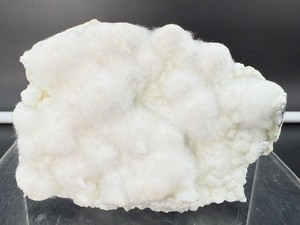 lot 57 image: Okenite Extremely delicate, fibrous silicate mineral that forms in soft, white cotton ball clusters within basalt geodes.  192 gm  6.7 oz  A popular collectors item.