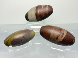 lot 103 image: Shiva Lingam Lot of 3 Sacred, eff-shaped stone from the Narmada River in India. Represents the Hindu Deity Lord Shiva. 519 gm  1 lb. 2.3 oz.