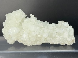 lot 109 image: Gorgeous White Aragonite Stalactite  254 gm.  8.9 oz. is a natural mineral formation composed of calcium carbonate that grows in caves.  Often called cave calcite or cave popcorn. Popular as mineral specimens for collectors.