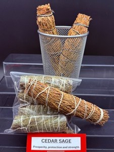 lot 86 image: Cedar Sage Bundles Lot of 7 generally refers to a bundle of white sage & cedar, dried and bound together for smudging ceremonies. Believed to attract good spirits. Three 6 bundles and four 4 bundles   is