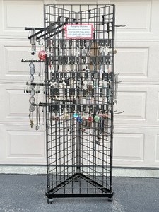 lot 73 image: Triangle Black Wire Grid Tower with Base and Casters included attached mirror.  Jewelry and grid accessories not included. Will be sold in Part 3 of this auction.