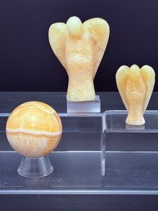 lot 179 image: Honey Calcite Polished Lot of 3 2 angels and a sphere. large. angel137 gm  4.8 oz  small angel 38 gm  1.3 oz.  sphere 63mm, 174 gm  6.2 oz  Total Weight 360gm  12.3 oz