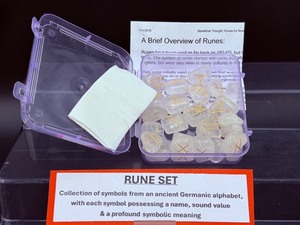 lot 174 image: Clear Quartz Rune Set (new) in Plastic Case Feature 25 stones (24 engraved with the Elder Futhark alphabet and one blank rune)