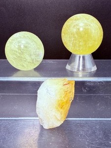 lot 203 image: Citrine Polished and Rough Lot of 3 sphere 40mm  111 gm  4 oz., sphere 37 mm  86 gm  3.1 oz. rough piece 42 gm  1.4 oz. Total Weight 239 gm  8.5 oz.