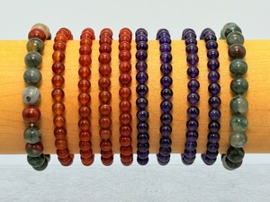 lot 48 image: Lot of 10 6mm & 8mm gemstone bracelets 4 carnelian, 4 amethyst, 2 bloodstone.  Stand not included.