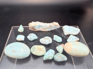 lot 290 image: Gorgeous Larimar Polished Misc. Pieces Lot Only found in the Dominican Republic.  2 palmstones, 2 slabs, 10 tumbles palmstones 58 gm  2 oz.  2 small slabs 43 gm  1.5 oz.  tumbles 45 gm  1.5 oz.  Total Lot Weight 144 gm  5 oz.