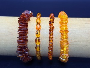 lot 138 image: High Quality Lithuanian Amber Bracelets Lot of 4 is a fossilized tree resin from the Baltic Sea.  Highly prized today, known fo unique inclusions like insects & plants that offer a glimpse into prehistoric life.