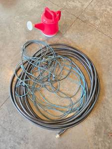 lot 48 image: Outdoor Watering Set with Garden Hose and Red Watering Can