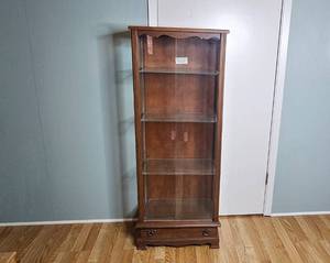 lot 130 image: Glass Front Curio Cabinet with Maple Finish and Drawers, 55x21x12 Inches