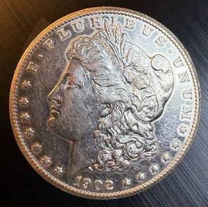lot 53 image: AU Semi-Key 1902 S Morgan Silver Dollar, harshly cleaned