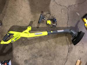 lot 60 image: RYOBI ONE 18V 10 in. Cordless Battery String TrimmerEdger with 2.0 Ah Battery and Charger  Customer Returns See Pictures