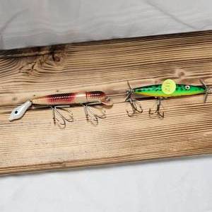 lot 211 image: Manns Classic Hard Worm and Heddon Flutter