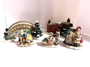 lot 32 image: 5 Unmarked Porcelain Christmas Village Figurines Bridge, Wall, Carolers Etc.