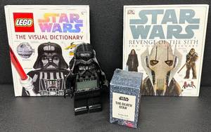 lot 115 image: Star Wars Collector Lot LEGO Visual Dictionary, Revenge of the Sith Book, Darth Vader LEGO Clock, Death Star Candle